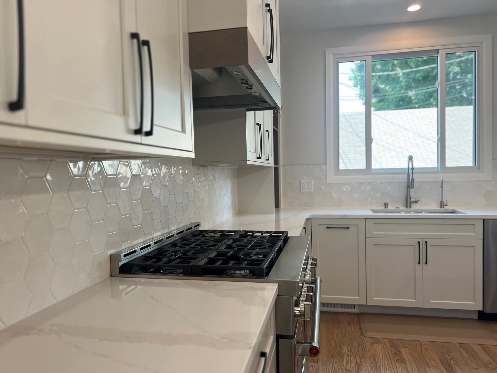 Kitchen with hexagon tile detail by PrestigeCore