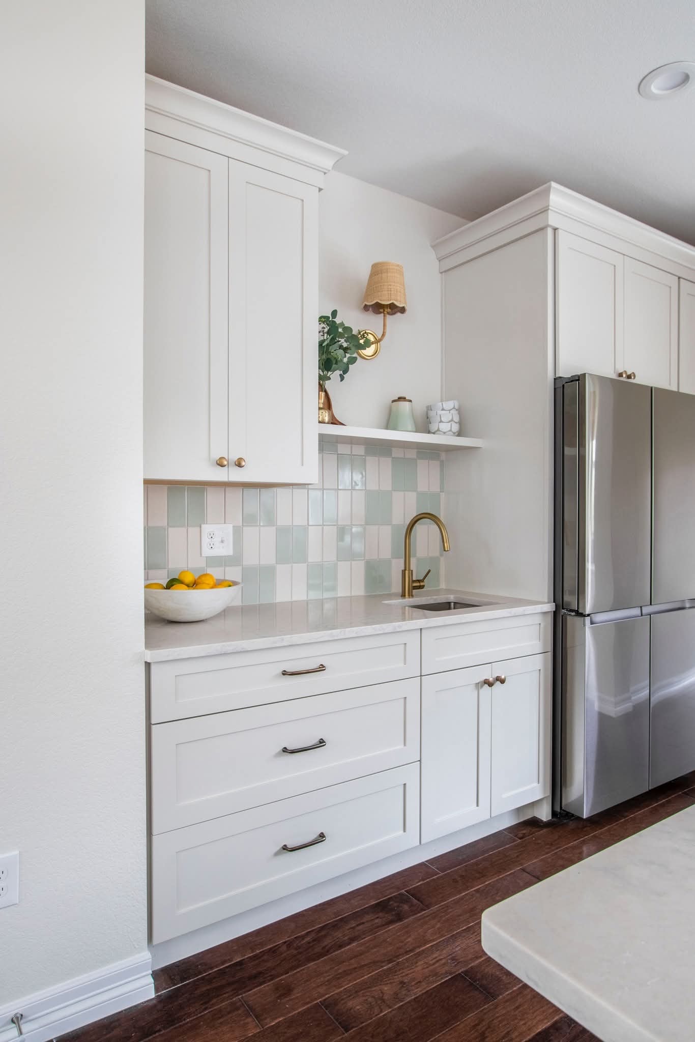 White kitchen with brass hardware by PrestigeCore